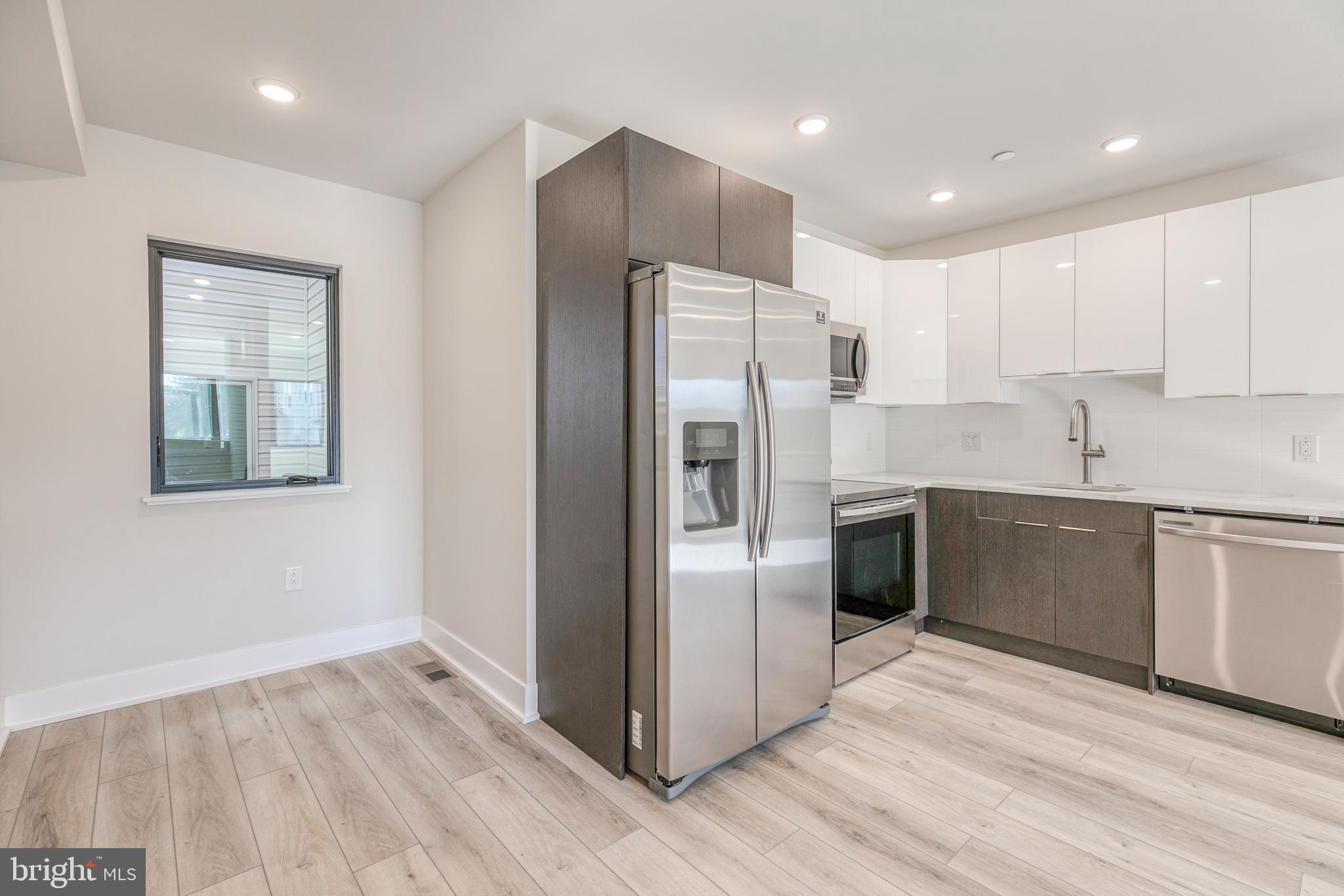 1506 North 8th Street, Unit 1 Philadelphia, PA 19122 - Photo 3 of 18 a kitchen with stainless steel appliances a refrigerator sink and cabinets