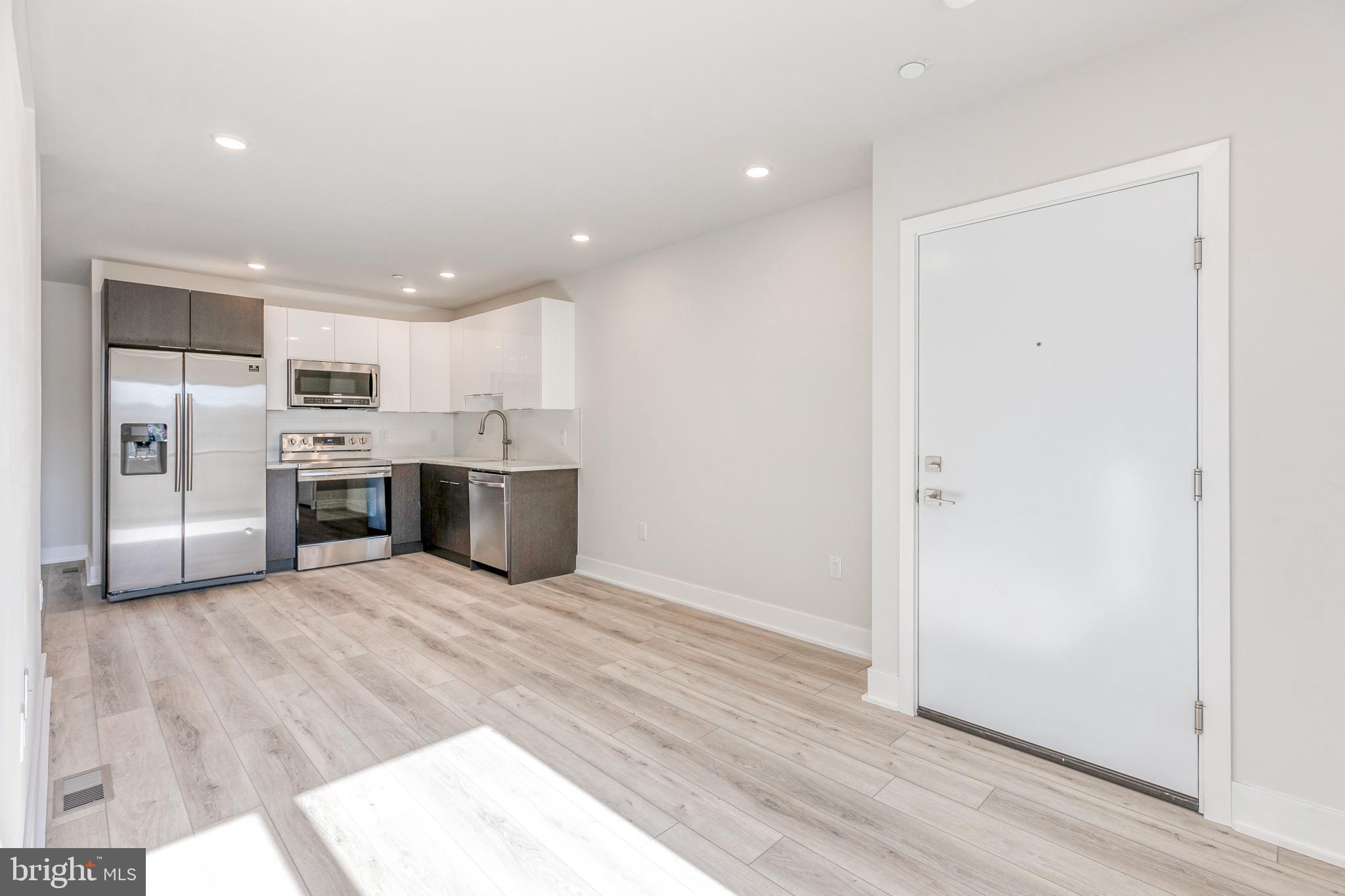 1506 North 8th Street, Unit 1 Philadelphia, PA 19122 - Photo 5 of 18 a view of kitchen with stainless steel appliances a refrigerator and a microwave