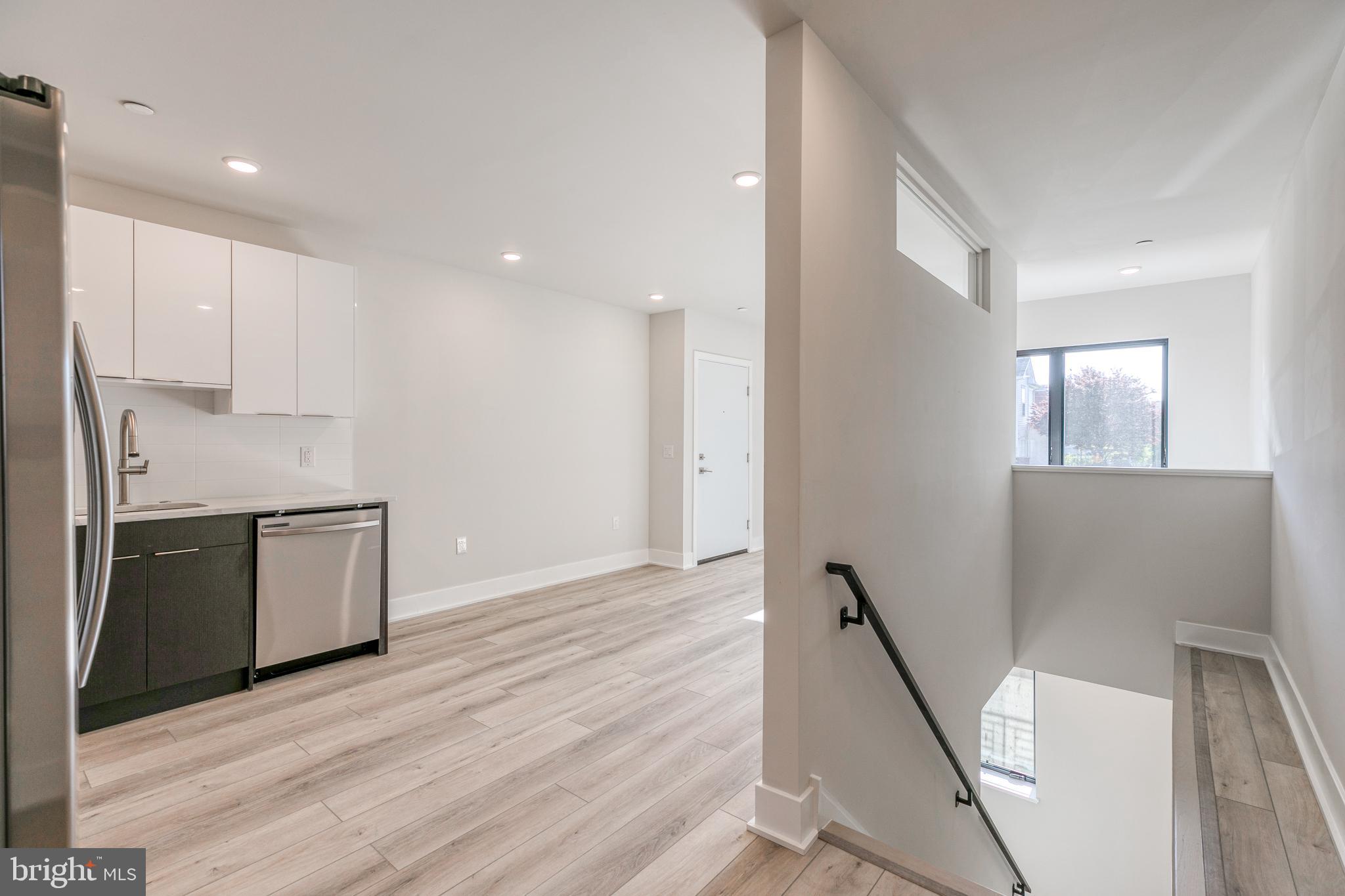 1506 North 8th Street, Unit 1 Philadelphia, PA 19122 - Photo 8 of 18 a kitchen with a refrigerator and a stove top oven