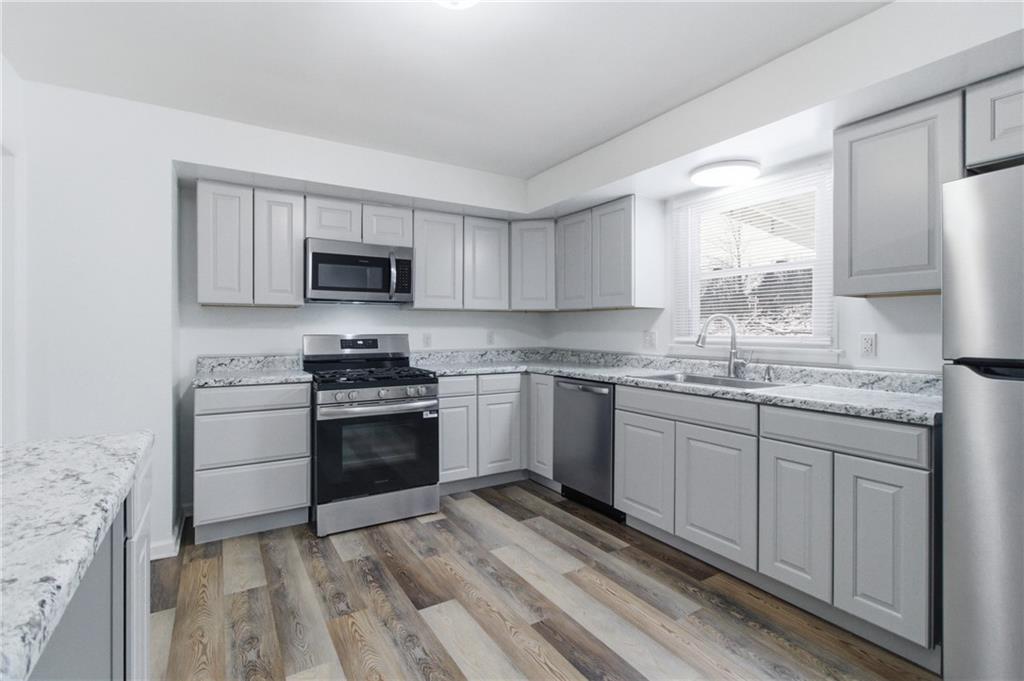 185 Sunset Drive Indiana, PA 15701 - Photo 15 of 29 a kitchen with granite countertop a stove a sink and a microwave