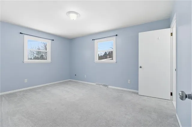 an empty room with a bathroom and a toilet