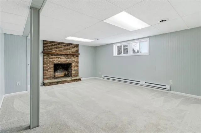 an empty room with furniture and a fireplace