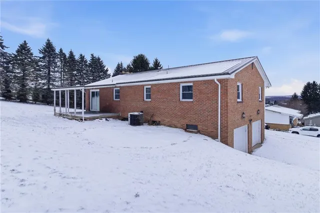 a backyard of a house with wooden fence and trees