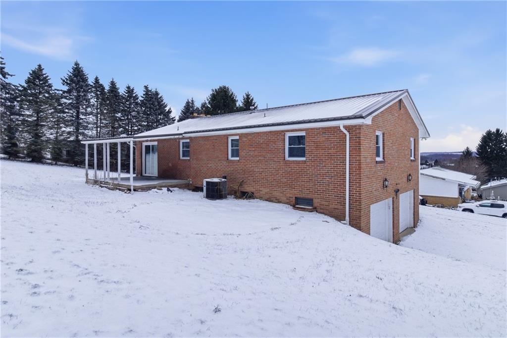 185 Sunset Drive Indiana, PA 15701 - Photo 3 of 29 a backyard of a house with wooden fence and trees