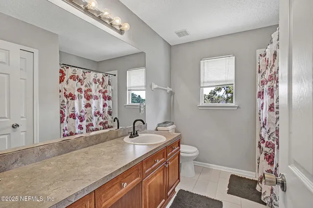 a bathroom with a sink a vanity and a toilet