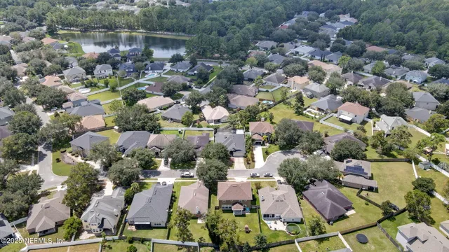 an aerial view of a houses with yard