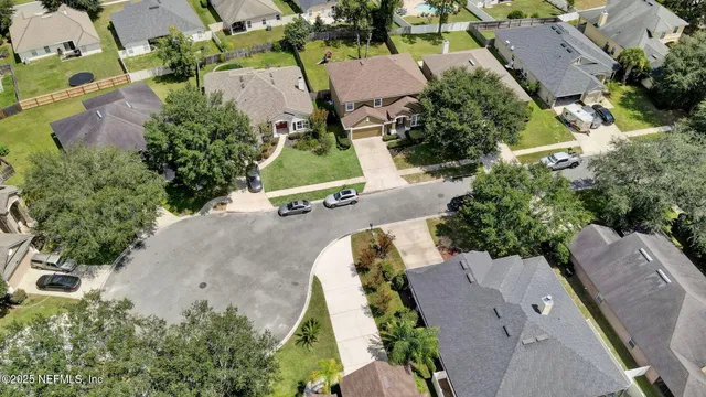 an aerial view of a house with a yard and pool