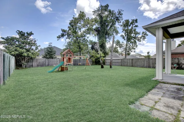 a view of a backyard with a garden and entertaining space