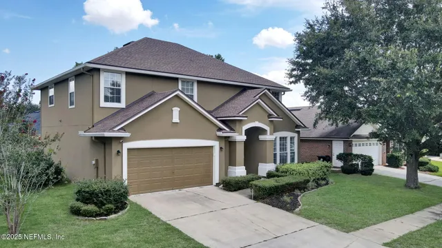 a front view of a house with a garden and plants