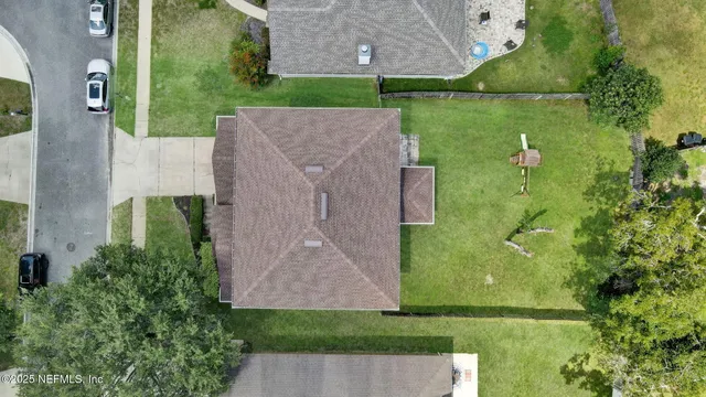 an aerial view of a house with a yard