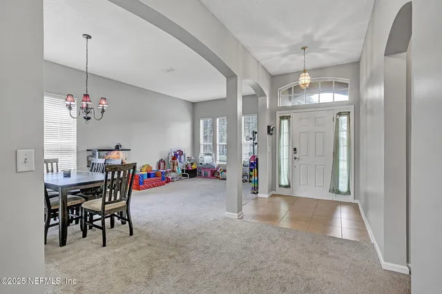 a view of a room with furniture and chandelier