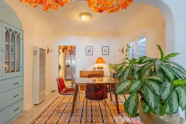 a view of a dining room with furniture and a potted plant