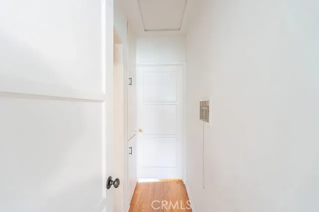 a storage room with lots of clutter and white cabinets