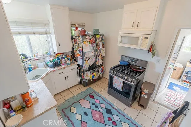 a kitchen with stainless steel appliances a stove a sink and a refrigerator