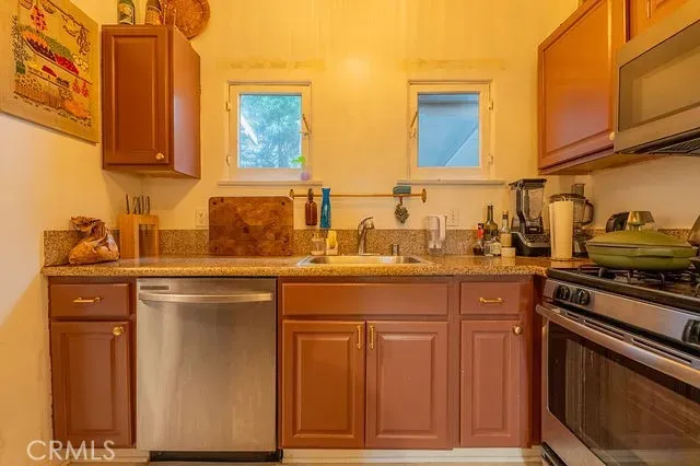 a utility room with a sink and a mirror