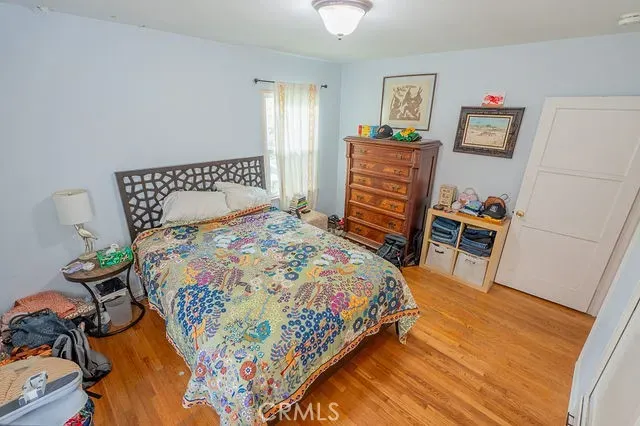 a bedroom with a bed and a dresser in it