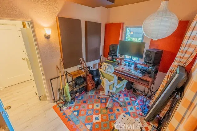 a view of a workspace with furniture and a window