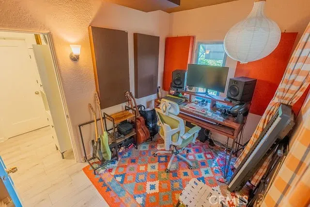 a view of a workspace with furniture and a window