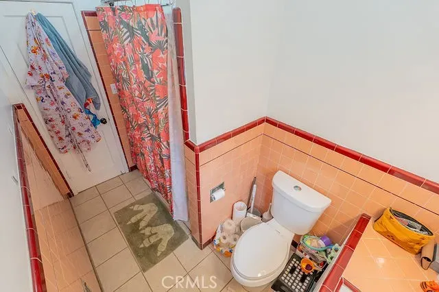 a white toilet sitting next to a bath tub