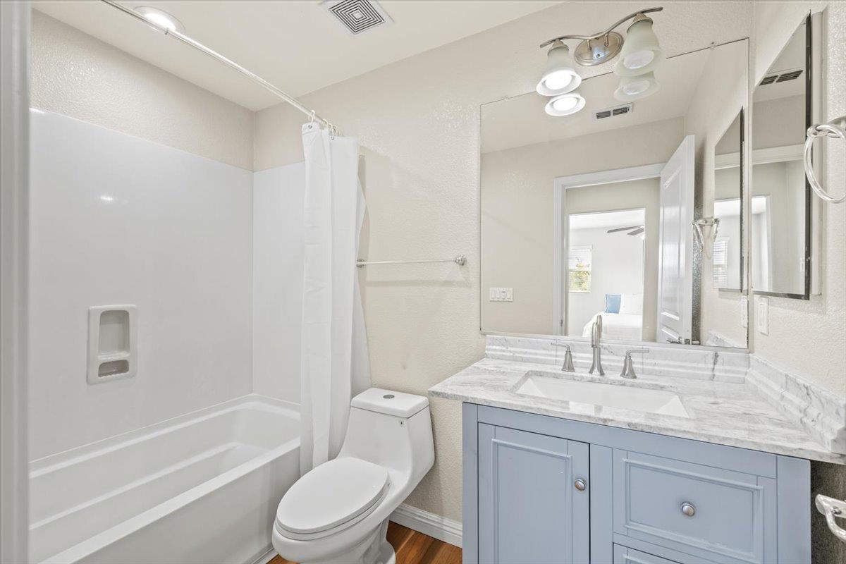 1000 Impressionist Loop Roseville, CA 95747 - Photo 23 of 33 a bathroom with a granite countertop sink a toilet a mirror a bathtub and shower