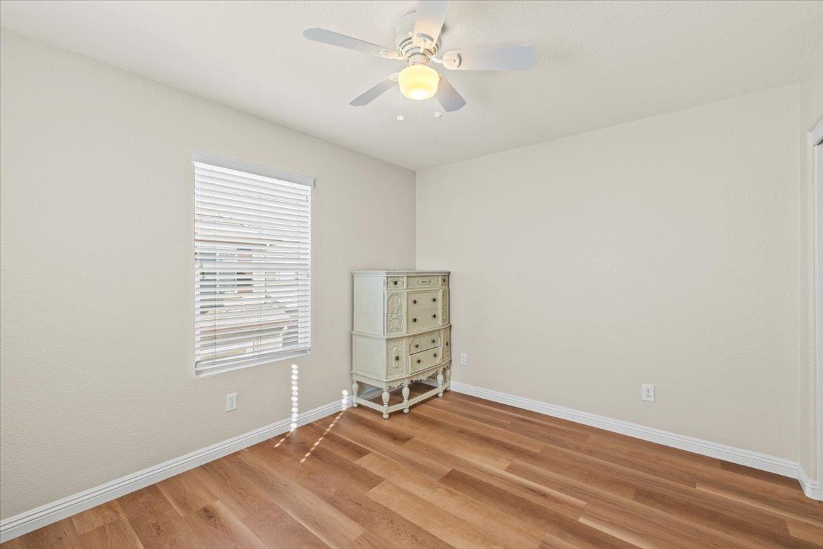 1000 Impressionist Loop Roseville, CA 95747 - Photo 29 of 33 an empty room with chandelier fan and windows