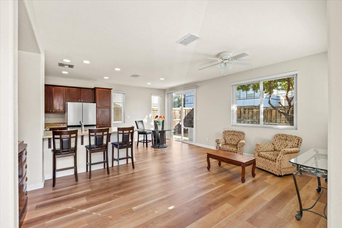 1000 Impressionist Loop Roseville, CA 95747 - Photo 5 of 33 a living room with furniture a dining table and kitchen view