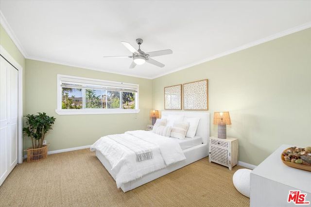 a bedroom with a bed and a painting on the wall