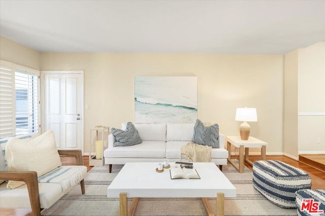 a living room with furniture and a lamp