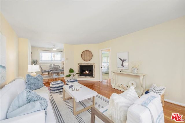 a living room with furniture a fireplace and a window