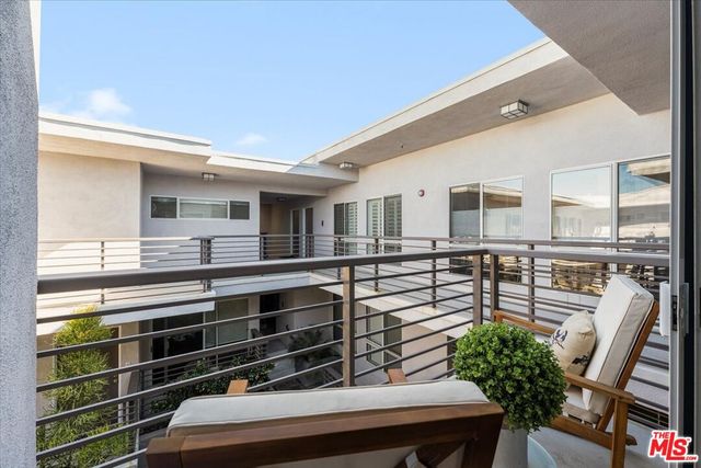 a view of a chairs and table in the balcony