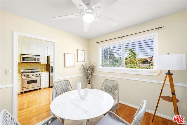 a living room with stainless steel appliances furniture and a fireplace