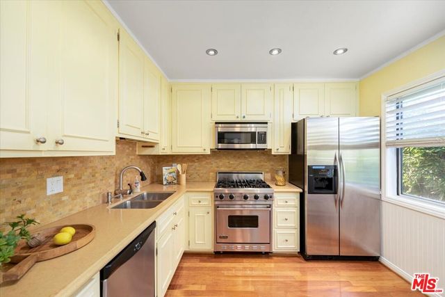 a kitchen with a sink a refrigerator and window