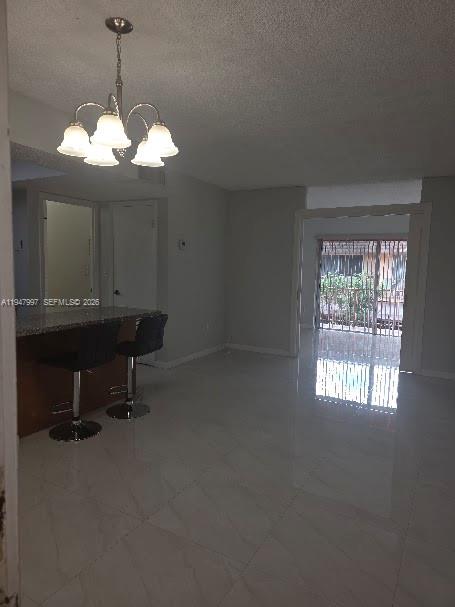 810 Southwest 129th Place, Unit 206 Miami, FL 33184 - Photo 3 of 16 a view of a room with a chandelier fan and a window