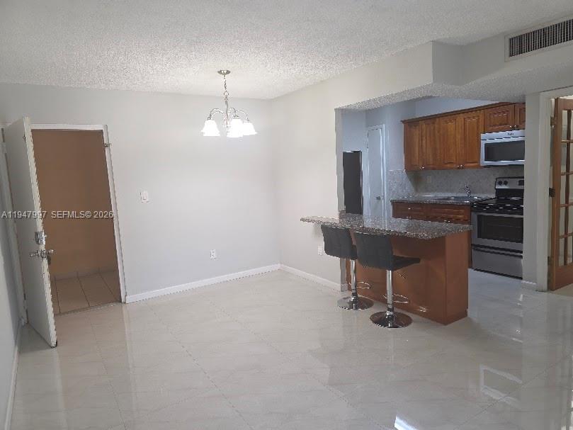 810 Southwest 129th Place, Unit 206 Miami, FL 33184 - Photo 4 of 16 a view of a kitchen with a sink and a refrigerator