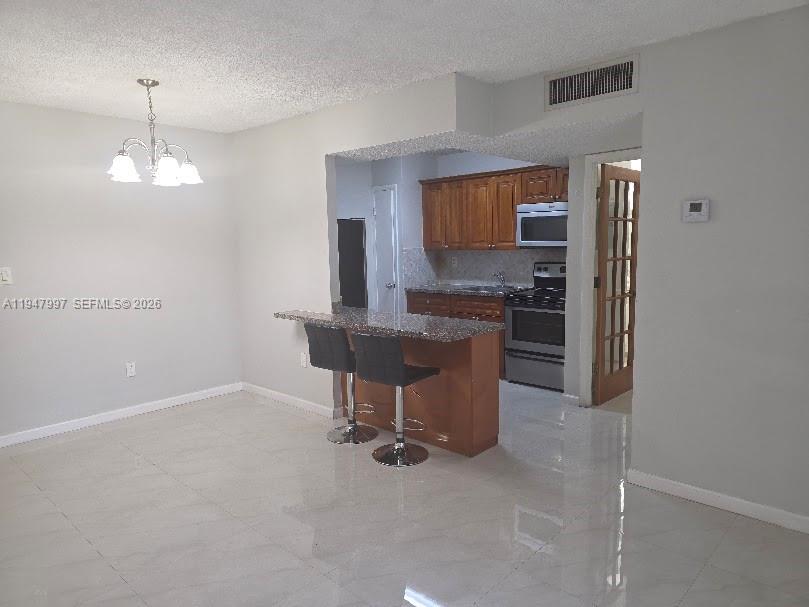 810 Southwest 129th Place, Unit 206 Miami, FL 33184 - Photo 5 of 16 a view of a kitchen and microwave