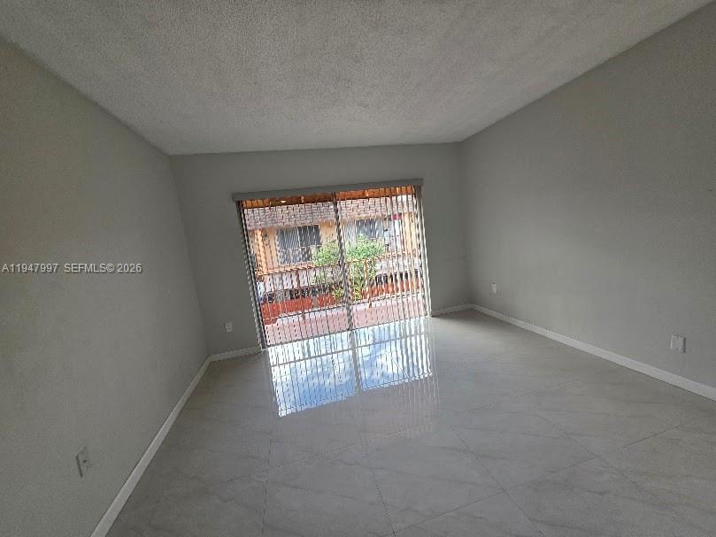 810 Southwest 129th Place, Unit 206 Miami, FL 33184 - Photo 9 of 16 an empty room with windows