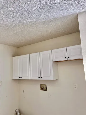 a view of kitchen with white cabinets