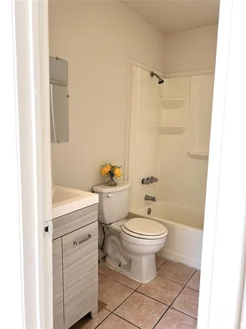 a bathroom with a sink a toilet and shower curtain