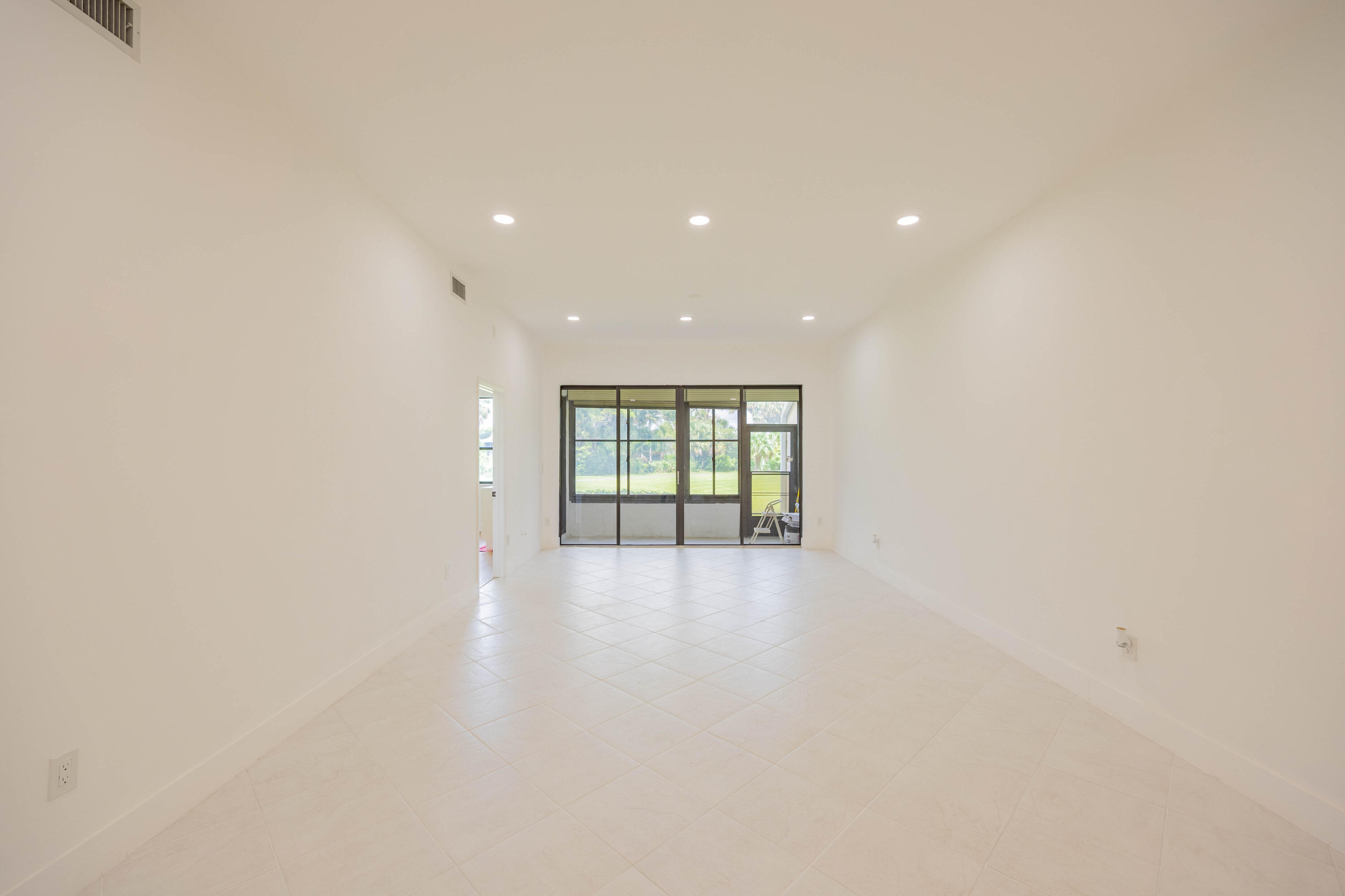 7520 La Paz Boulevard, Unit 104 Boca Raton, FL 33433 - Photo 22 of 56 a view of an empty room with glass door