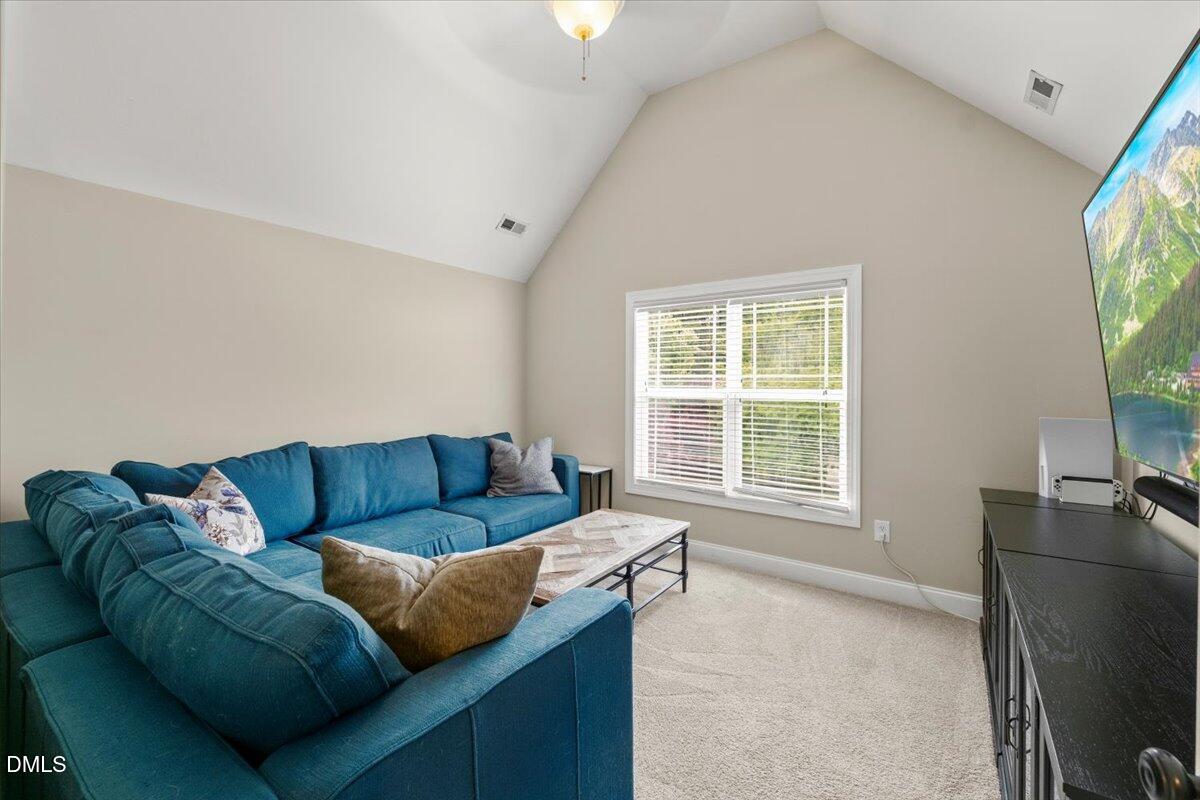 7400 Denlee Road Raleigh, NC 27603 - Photo 30 of 47 a living room with furniture and a flat screen tv