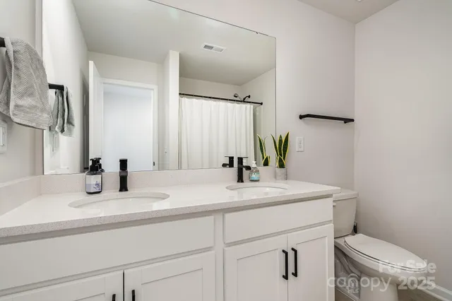 a bedroom with a bed and a potted plant
