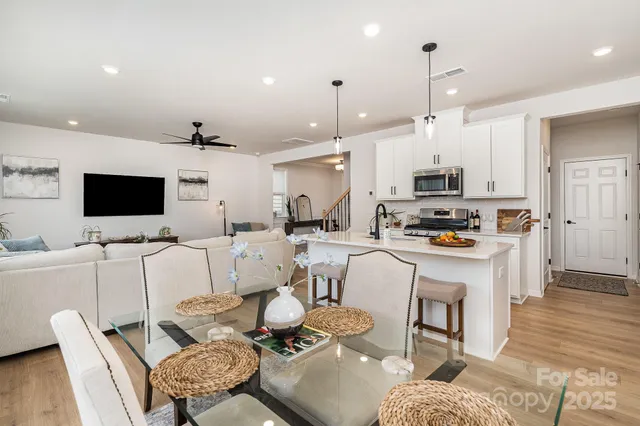 a kitchen with stainless steel appliances a stove microwave sink refrigerator and cabinets