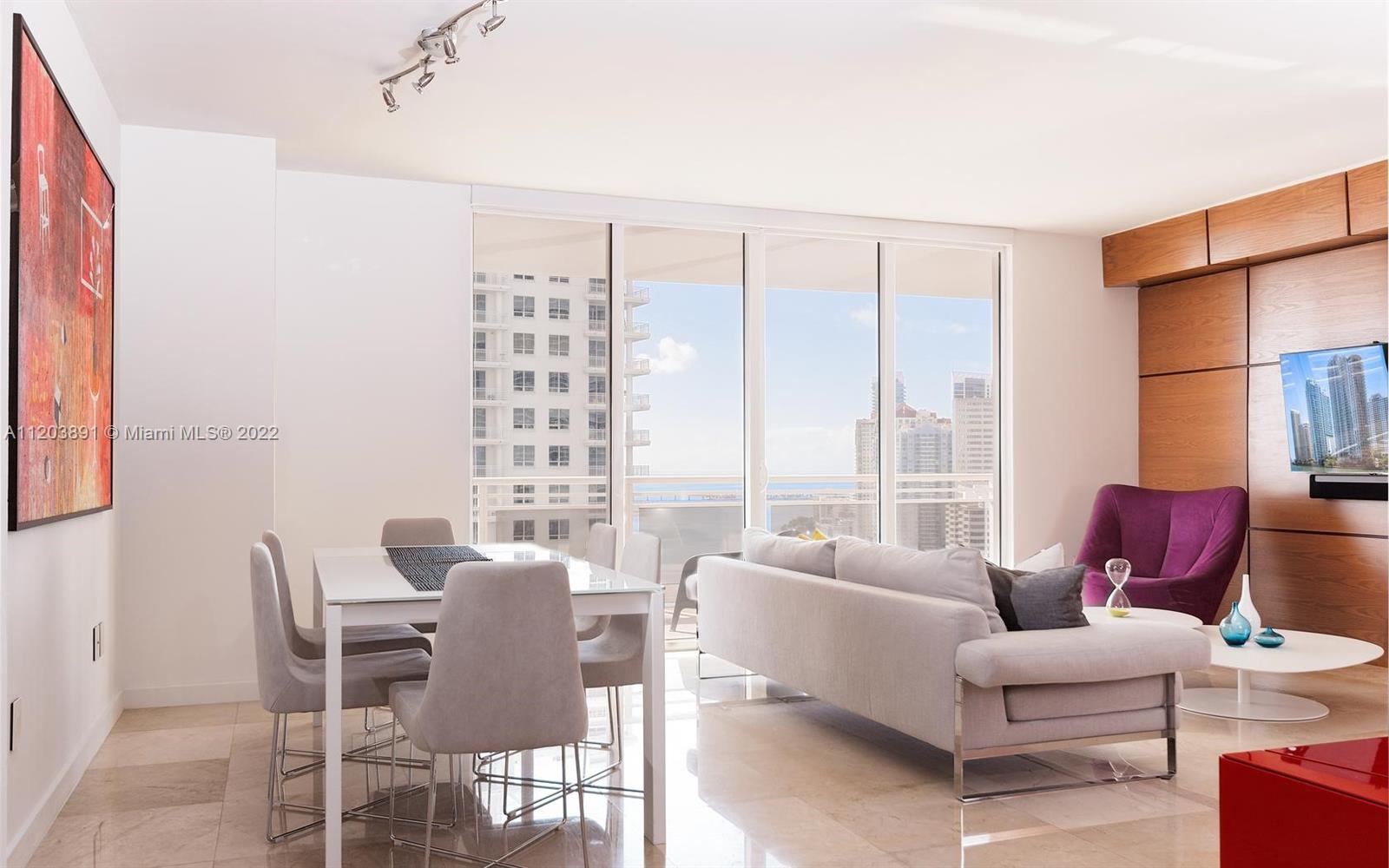901 Brickell Key Boulevard, Unit 2503 Miami, FL 33131 - Photo 1 of 19 a living room with furniture and a large window