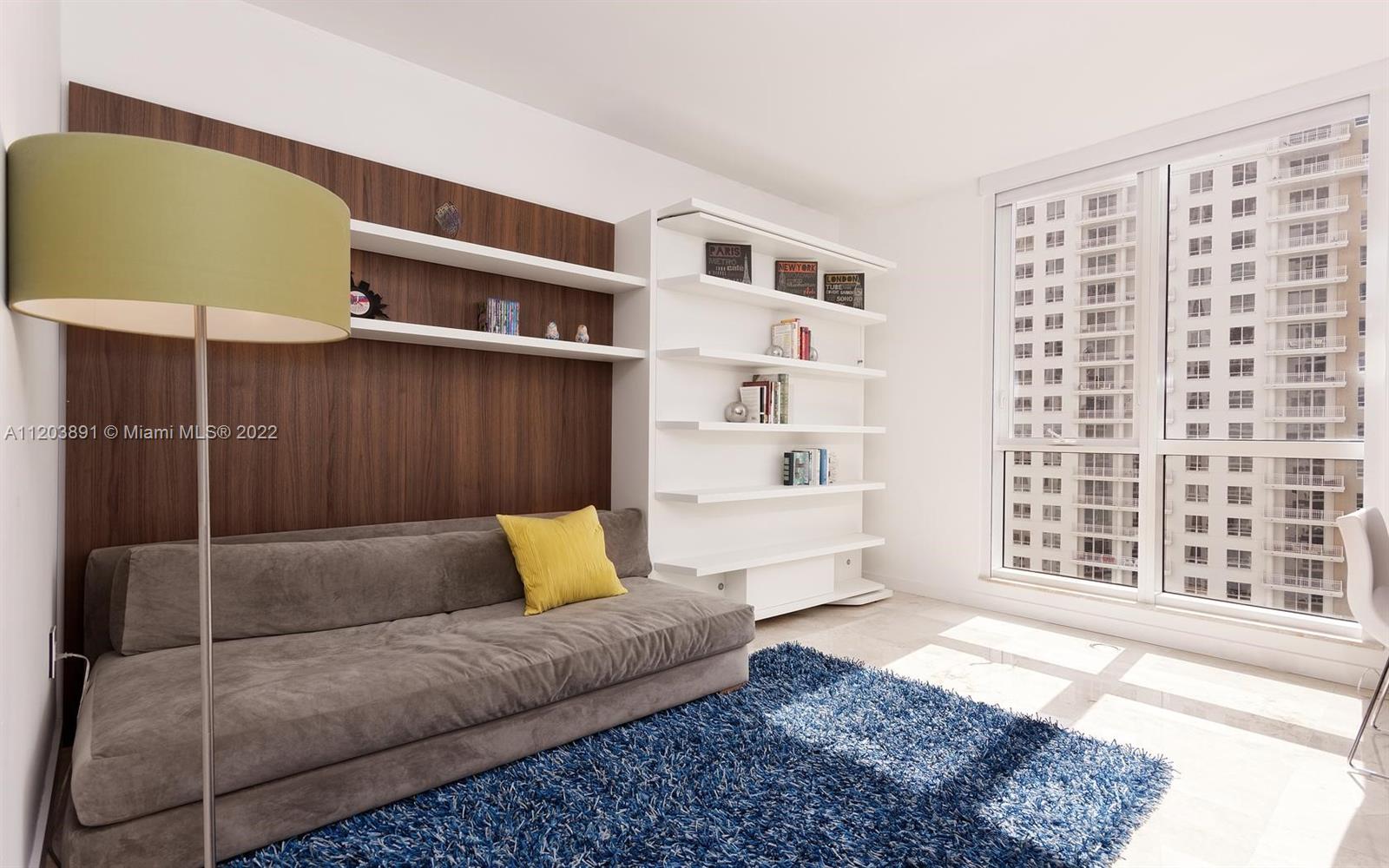 901 Brickell Key Boulevard, Unit 2503 Miami, FL 33131 - Photo 14 of 19 a living room with furniture lamp and rug