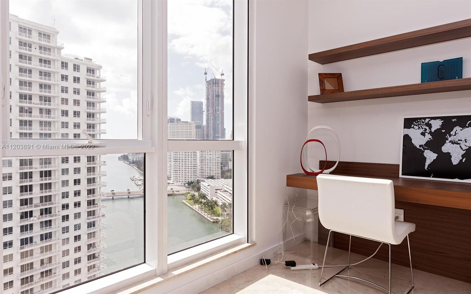 901 Brickell Key Boulevard, Unit 2503 Miami, FL 33131 - Photo 16 of 19 a balcony with table and chairs