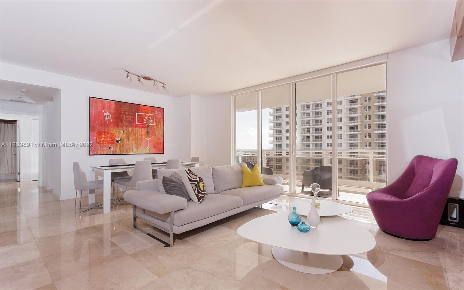 901 Brickell Key Boulevard, Unit 2503 Miami, FL 33131 - Photo 3 of 19 a living room with furniture and a large window