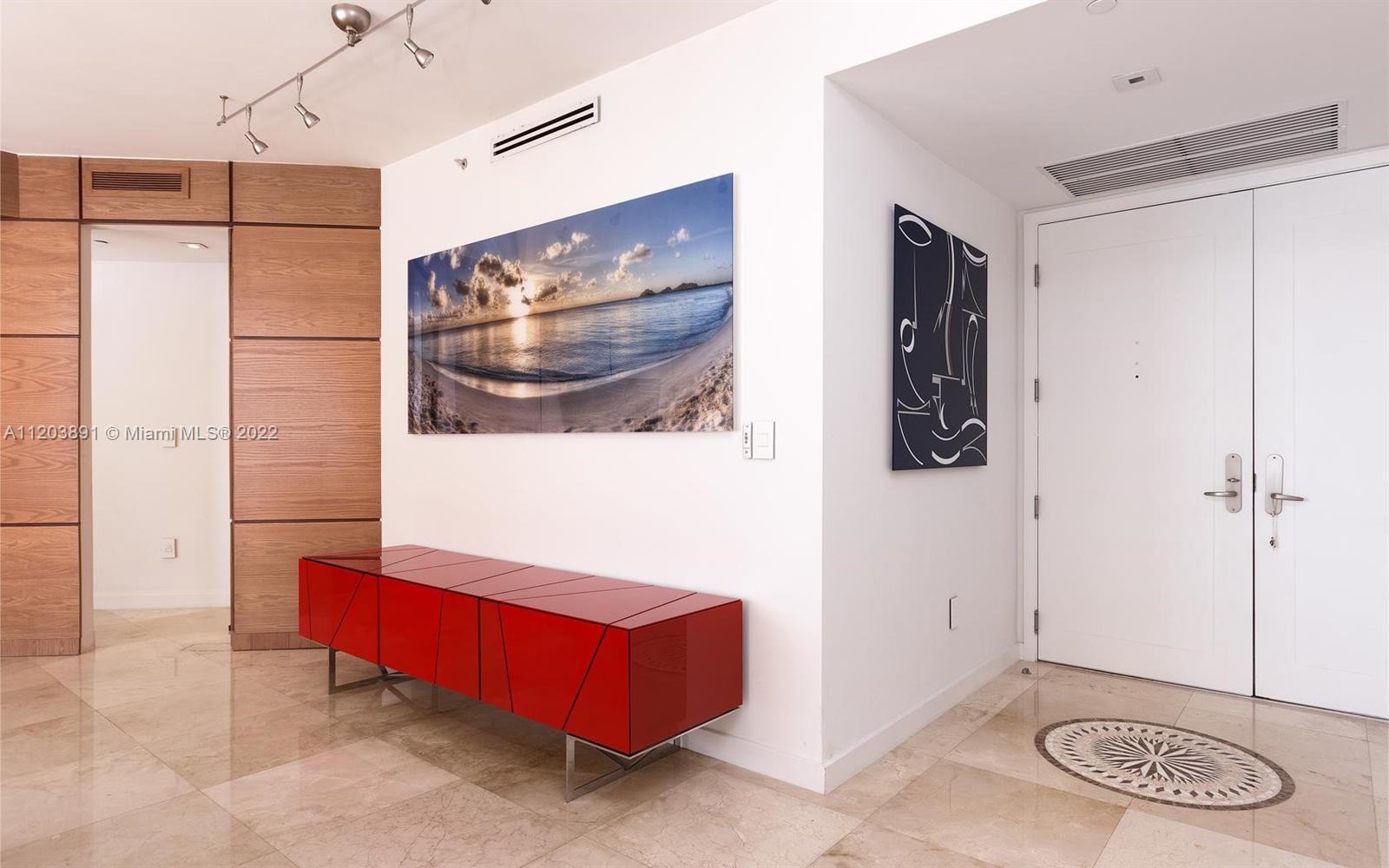 901 Brickell Key Boulevard, Unit 2503 Miami, FL 33131 - Photo 5 of 19 a living room with furniture and a table