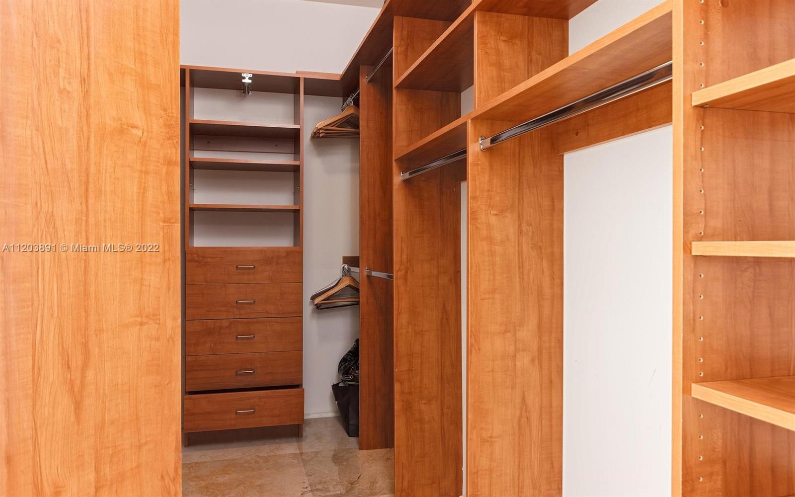 901 Brickell Key Boulevard, Unit 2503 Miami, FL 33131 - Photo 8 of 19 a view of walk in closet with empty racks