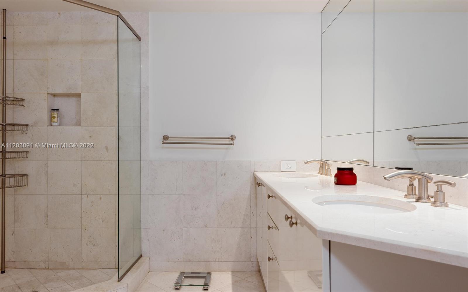 901 Brickell Key Boulevard, Unit 2503 Miami, FL 33131 - Photo 9 of 19 a bathroom with a sink and a mirror