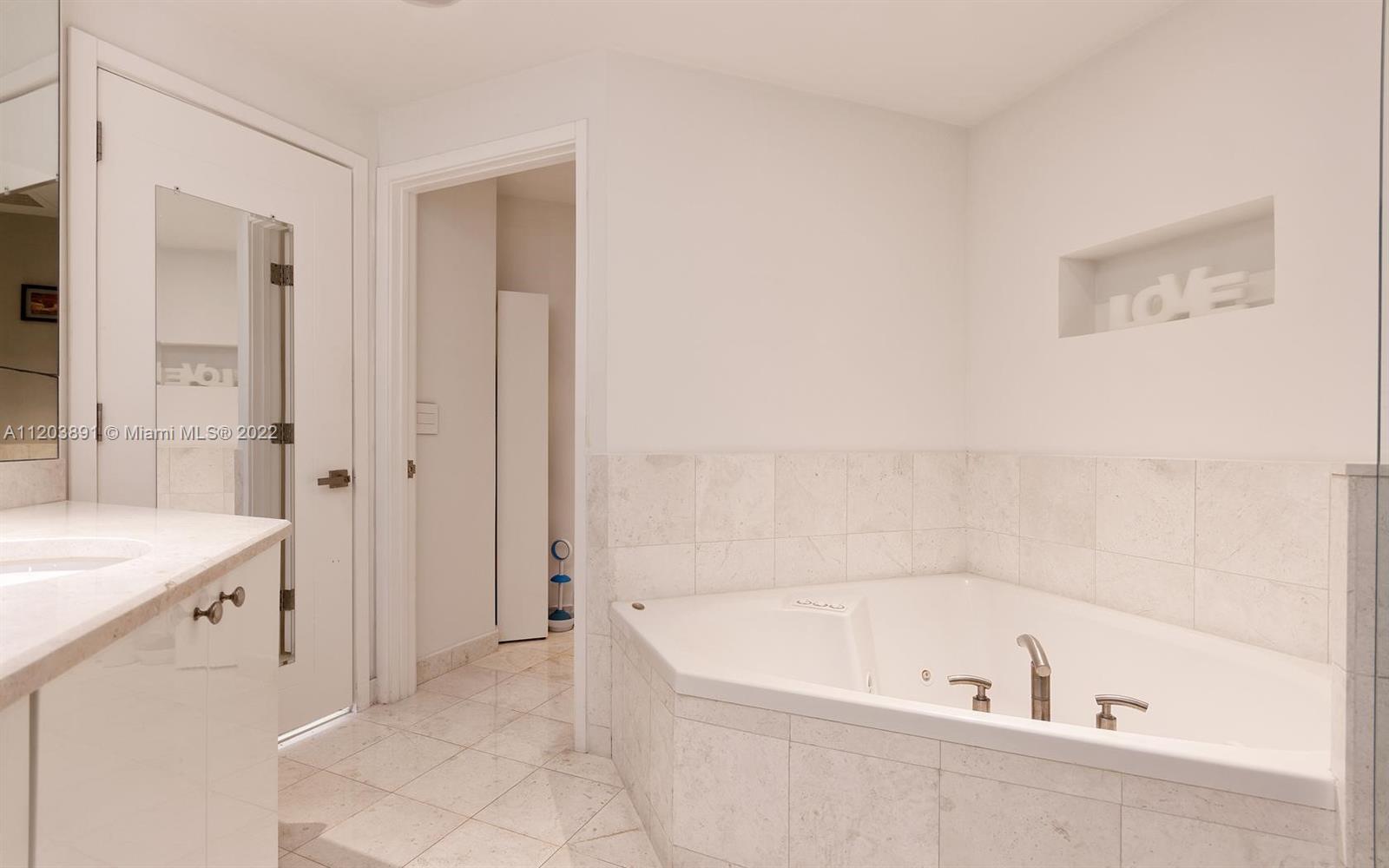 901 Brickell Key Boulevard, Unit 2503 Miami, FL 33131 - Photo 10 of 19 a bathroom with a bathtub and a sink